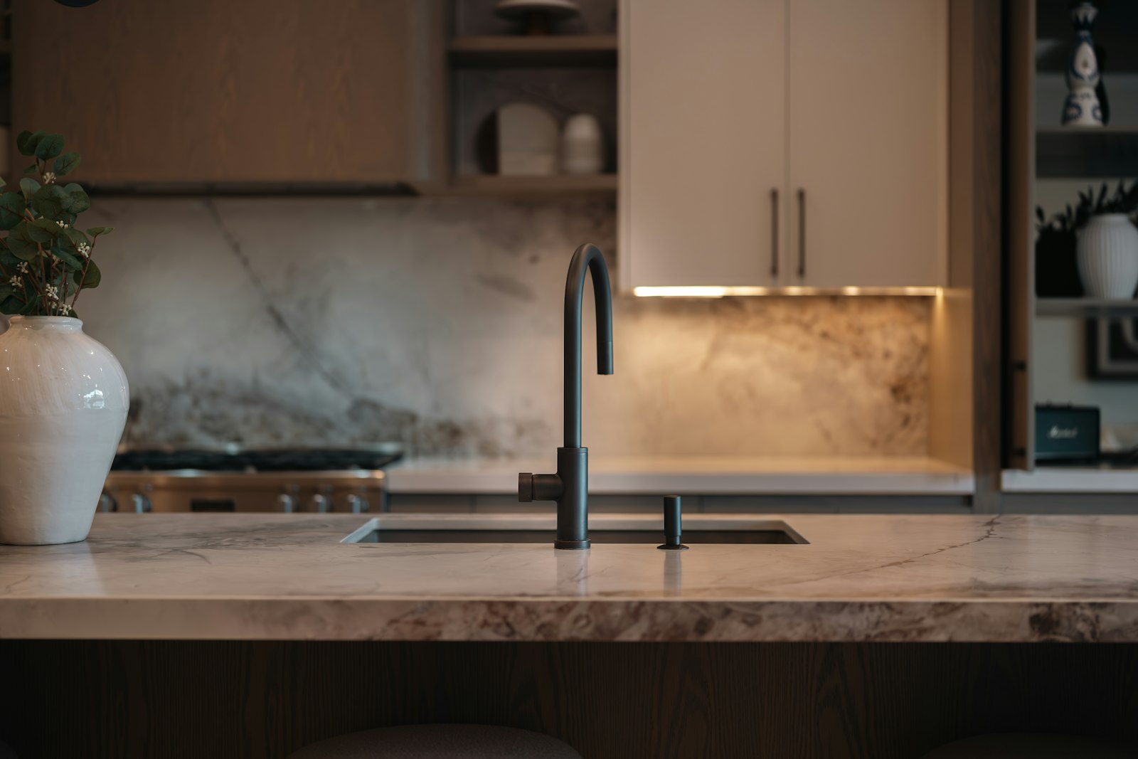 Marble kitchen island with brass faucet
